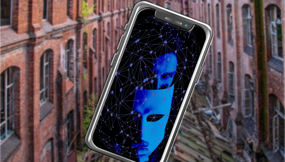 Sachsen-Anhalt AfD-Propaganda: Smartphone mit Masken-Grafik vor Industriekulisse